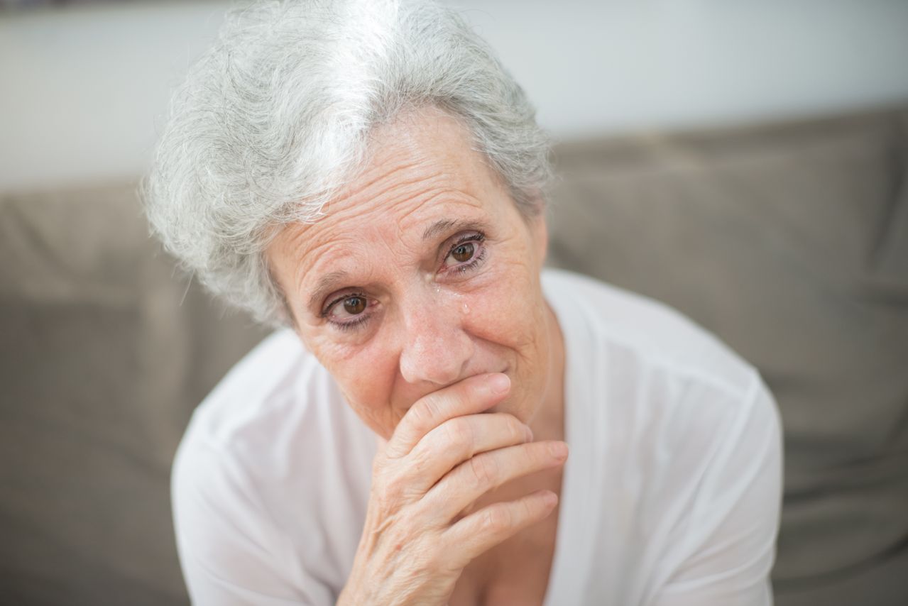 Family member supporting elderly person with Alzheimer's