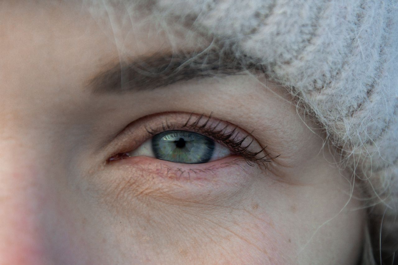 Elderly patient with cataracts receiving home eye examination