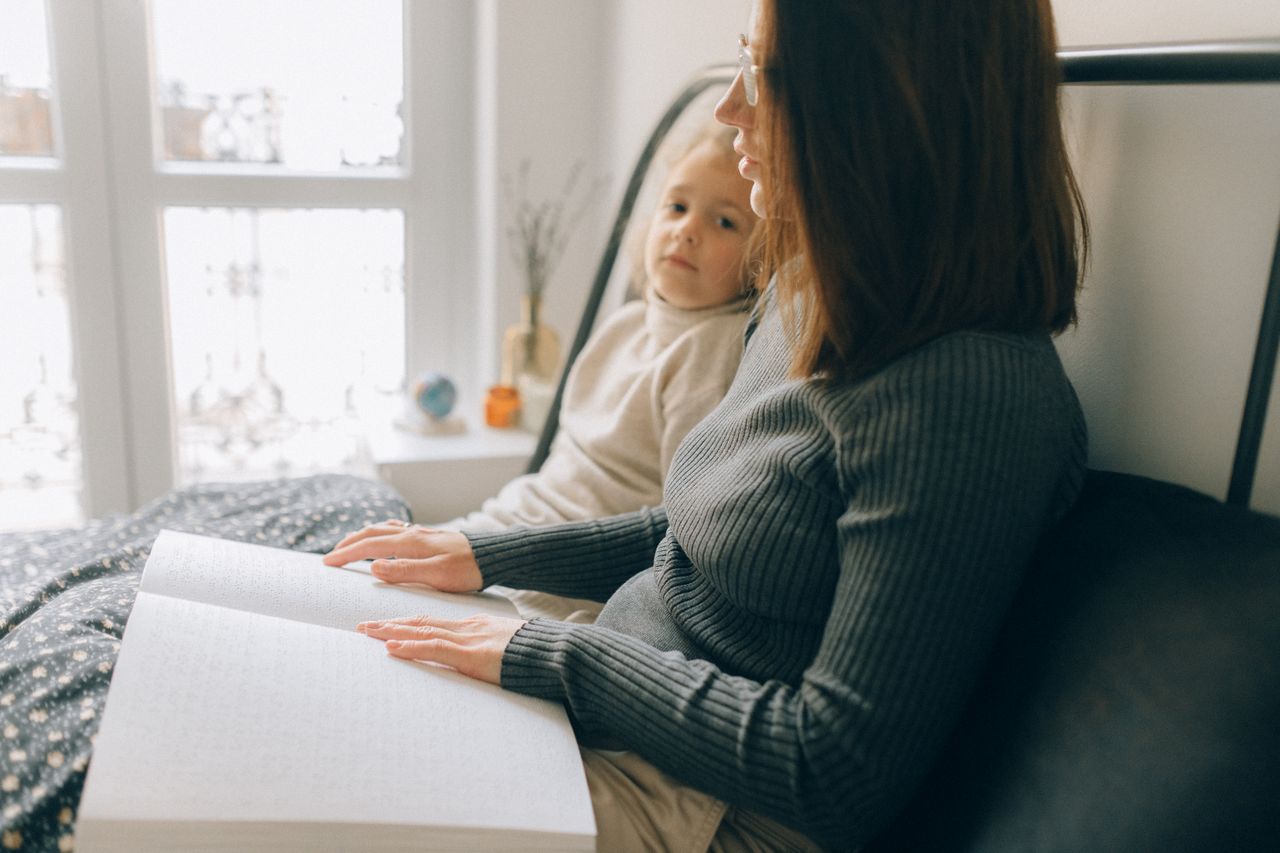 Supportive care worker with patient during home eye test
