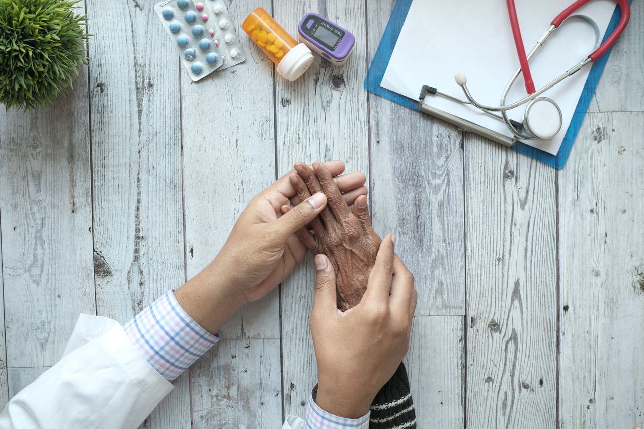 Optician visiting elderly patient at home