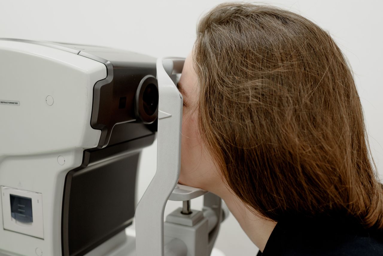 Optician dispensing glasses at elderly patient's home