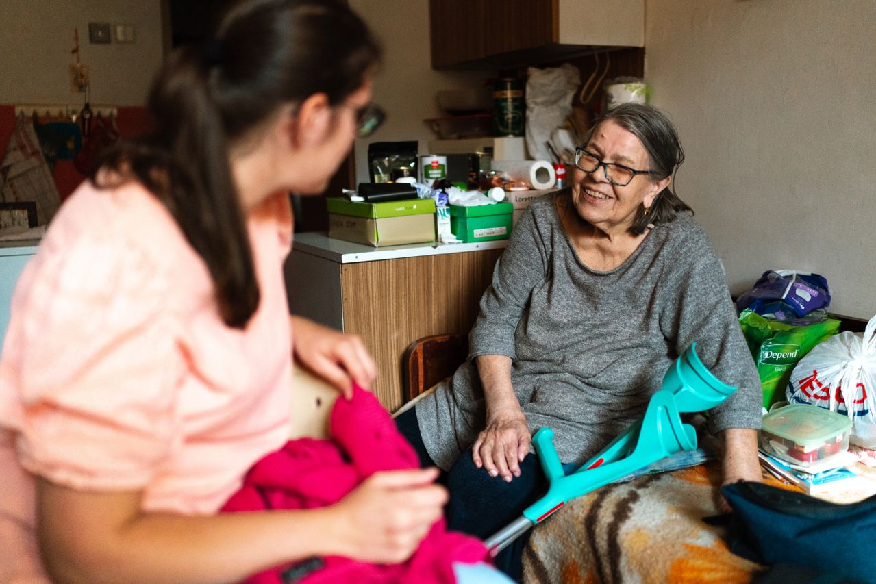 Care home manager speaking with optician during clinic visit