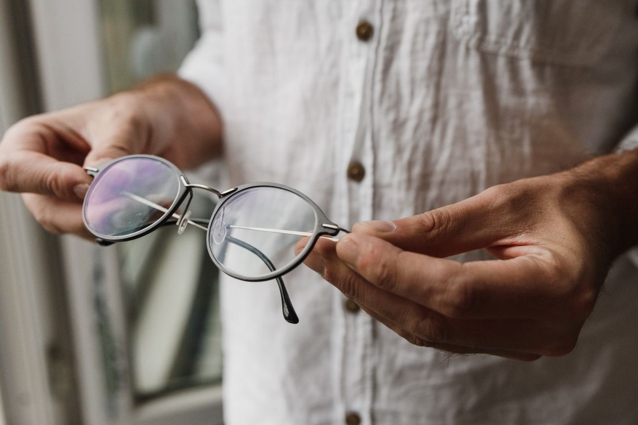 New glasses being fitted and adjusted at elderly patient's home